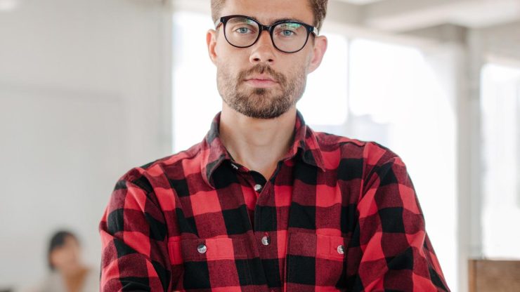 confident-young-entrepreneur-standing-in-office.jpg