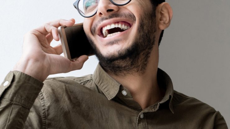 happy-young-casual-businessman-talking-on-mobile.jpg
