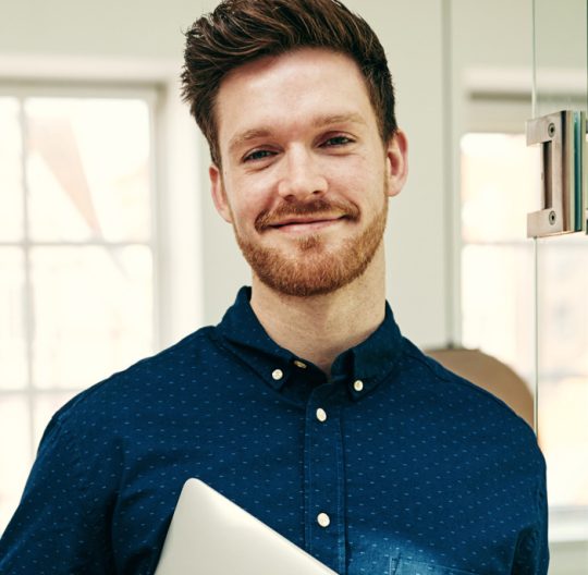 smiling-young-businessman-standing-with-his.jpg